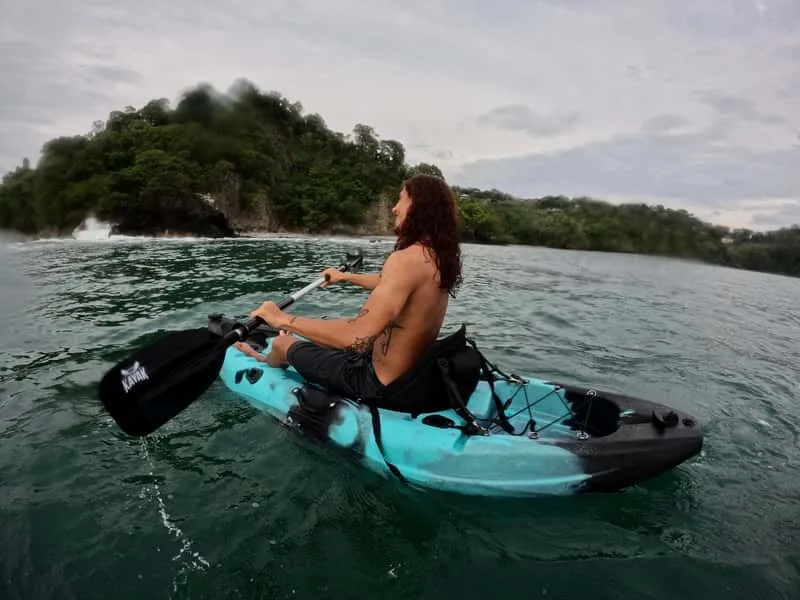 Kayakers paddling toward the secluded Biesanz Beach cove for a snorkeling adventure near Manuel Antonio National Park Costa Rica