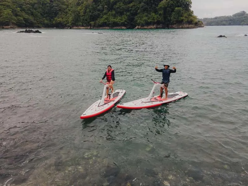Traveler pedaling a water bike across turquoise bay waters on a unique snorkeling tour in Manuel Antonio Costa Rica
